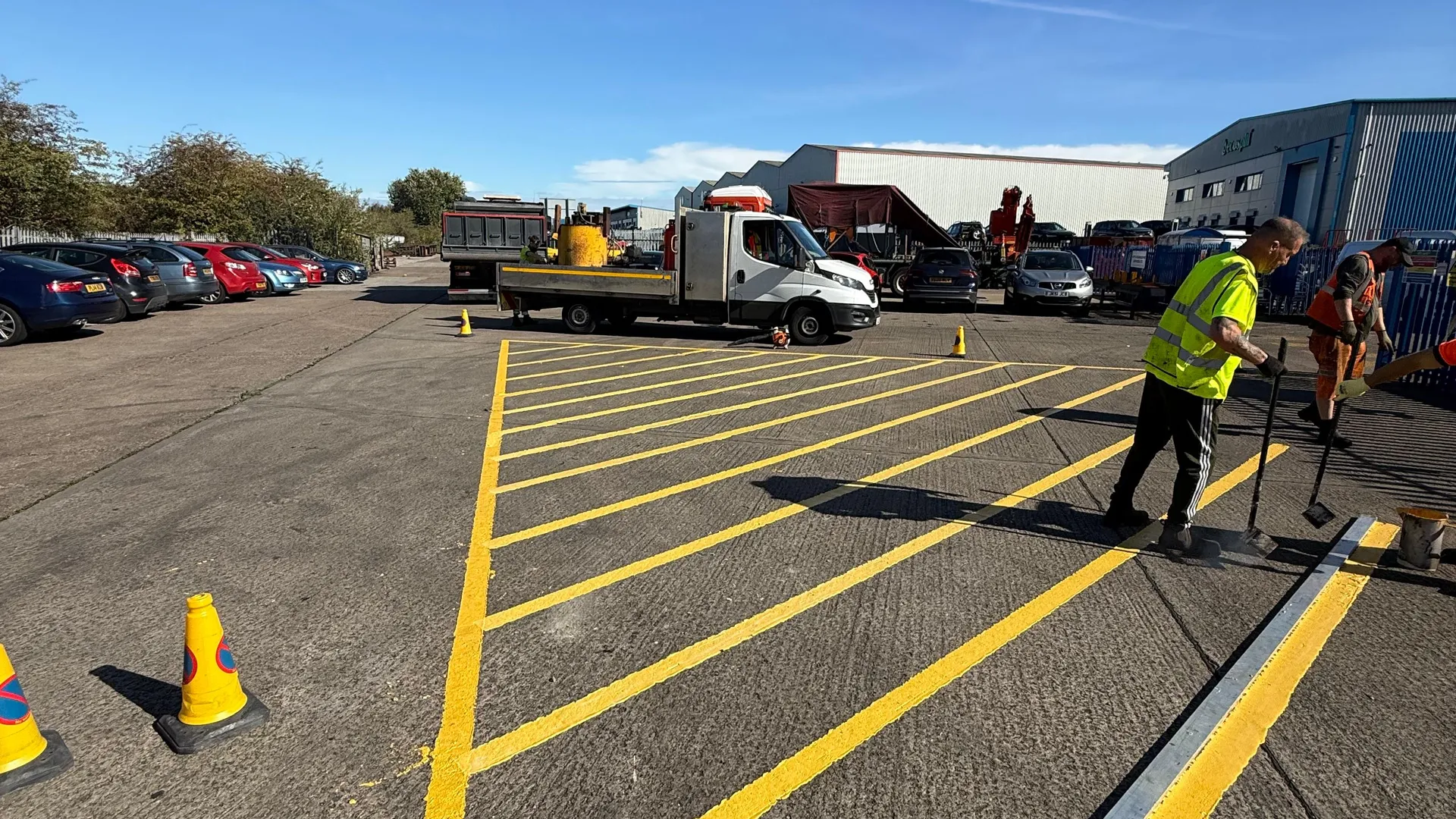 South Yorkshire Construction crew laying yellow thermoplastic markings in a depot yard